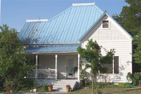 light blue house with gray metal roof|blue roof house.